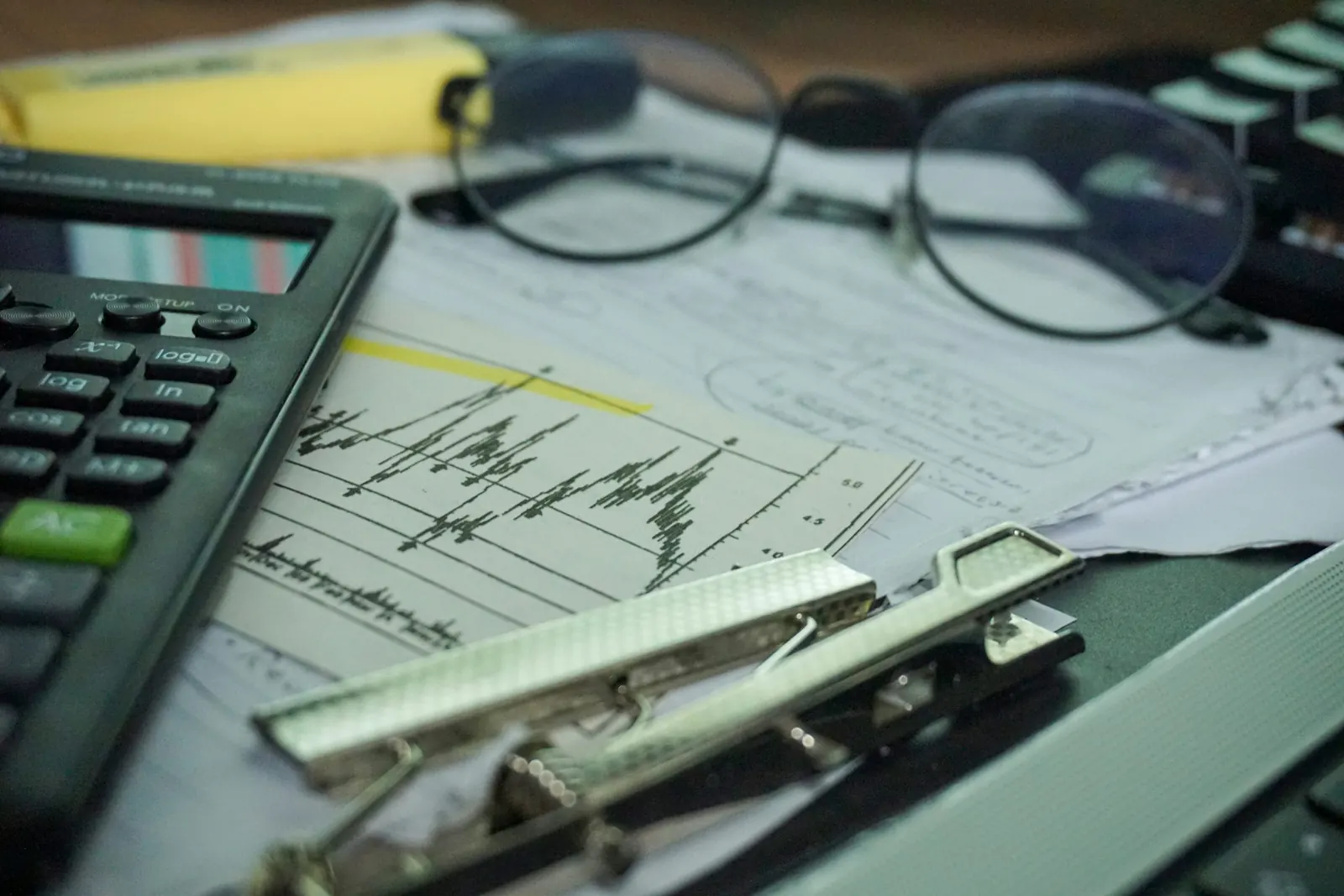 A calculator and notebook arranged for simple fundraising money planning